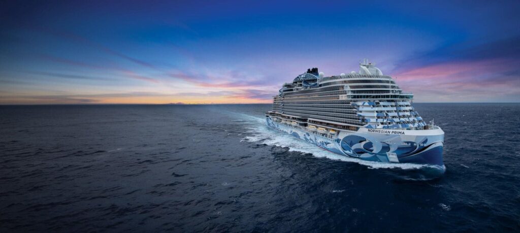 Norwegian Prima sailing at sea, with its name and blue hull artwork visible